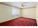 Bedroom features plush red carpet, yellow walls, and a floral border accent at 2145 Ne 45Th Ave # 2145, Ocala, FL 34470