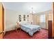 Comfortable bedroom with plush red carpet, a large window, and modern lamps at 2145 Ne 45Th Ave # 2145, Ocala, FL 34470