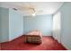 Cozy bedroom featuring blue walls, a ceiling fan, and a bed with a patterned comforter at 2145 Ne 45Th Ave # 2145, Ocala, FL 34470