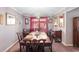 Elegant dining room with a chandelier, large table with seating for eight, and ample natural light at 2145 Ne 45Th Ave # 2145, Ocala, FL 34470