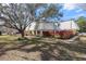 Charming townhouse with a well-maintained lawn, mature tree, and a red privacy fence on a sunny day at 2145 Ne 45Th Ave # 2145, Ocala, FL 34470