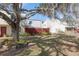 Charming townhouse boasts a lush front yard with mature tree and a red picket fence at 2145 Ne 45Th Ave # 2145, Ocala, FL 34470
