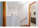 Staircase landing with a chandelier, seamlessly connecting to a hallway and a glimpse of a nearby bathroom at 2145 Ne 45Th Ave # 2145, Ocala, FL 34470