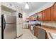 Traditional-style kitchen featuring warm wood cabinetry, tile backsplash, and stainless steel appliances at 2145 Ne 45Th Ave # 2145, Ocala, FL 34470