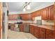 Traditional-style kitchen featuring warm wood cabinetry, tile backsplash, and stainless steel appliances at 2145 Ne 45Th Ave # 2145, Ocala, FL 34470