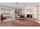 Spacious living room features a fireplace, built-in bookshelves, and grand piano at 2145 Ne 45Th Ave # 2145, Ocala, FL 34470