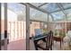 Sunroom with sliding glass doors leading to the backyard and mature landscaping at 2145 Ne 45Th Ave # 2145, Ocala, FL 34470