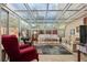 Bright sunroom with glass ceiling, comfortable seating, and tile flooring at 2145 Ne 45Th Ave # 2145, Ocala, FL 34470