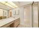 Bathroom with dual sinks, mirrored medicine cabinet, and a view into other rooms at 2321 Se 19Th Cir, Ocala, FL 34471