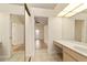 Bathroom with vanity, mirrored walls, and a view of another room at 2321 Se 19Th Cir, Ocala, FL 34471