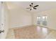 Bright bedroom with tile floors, ceiling fan, and sliding glass doors leading to a sunroom at 2321 Se 19Th Cir, Ocala, FL 34471