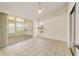 Bedroom with tile floors, sliding glass doors to a sunroom, and a ceiling fan at 2321 Se 19Th Cir, Ocala, FL 34471