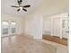 Large bedroom featuring tile floors, double doors, and hardwood floors in connecting room at 2321 Se 19Th Cir, Ocala, FL 34471