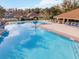 Relaxing community pool area with multiple pools and ample lounge chairs at 2321 Se 19Th Cir, Ocala, FL 34471