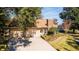 Exterior view of a condo showing a two-car garage, landscaping, and brick accents at 2321 Se 19Th Cir, Ocala, FL 34471