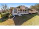 Rear view of house showcasing sunroom and landscaping at 2321 Se 19Th Cir, Ocala, FL 34471