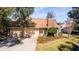 Front view of a condo with a brick chimney, two-car garage, and well-maintained lawn at 2321 Se 19Th Cir, Ocala, FL 34471