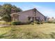 Tan house with manicured lawn and brick chimney at 2321 Se 19Th Cir, Ocala, FL 34471