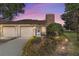 Evening view of condo exterior with landscaping and lighting at 2321 Se 19Th Cir, Ocala, FL 34471