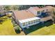 Back of house with sunroom and landscaping at 2321 Se 19Th Cir, Ocala, FL 34471