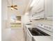 Kitchen boasts white cabinets, tile floor and view to backyard at 2321 Se 19Th Cir, Ocala, FL 34471