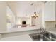 Kitchen with a breakfast bar overlooking the living room at 2321 Se 19Th Cir, Ocala, FL 34471
