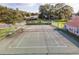 Community tennis court with benches and surrounding fencing at 2321 Se 19Th Cir, Ocala, FL 34471
