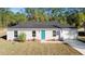 Newly constructed home with gray siding, teal door, and attached garage at 24025 Nw Foxglove Lane, Dunnellon, FL 34431