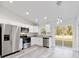 Open concept kitchen, stainless steel appliances, and wood-look floors at 24025 Nw Foxglove Lane, Dunnellon, FL 34431