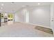 Open concept living room and kitchen with carpeted and wood-look floors at 24025 Nw Foxglove Lane, Dunnellon, FL 34431
