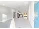 Open concept living room and kitchen with carpeted floors and stainless steel appliances at 24025 Nw Foxglove Lane, Dunnellon, FL 34431