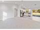 Open concept living area showcasing carpeted floors, kitchen, and view to backyard at 24025 Nw Foxglove Lane, Dunnellon, FL 34431