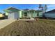 Front view of a light green house with a landscaped yard at 2580 Sw 168Th Pl, Ocala, FL 34473