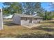 Back of home showing concrete patio and back yard at 26 Spring Cir, Ocala, FL 34472