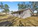 Back of home showing concrete patio and a view of the storage shed at 26 Spring Cir, Ocala, FL 34472
