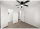Bright bedroom with ceiling fan, wood-look floors, and an en-suite closet and bathroom at 26 Spring Cir, Ocala, FL 34472