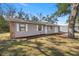 View of the renovated house with a new driveway and added mulch at 26 Spring Cir, Ocala, FL 34472