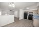 Bright, open-concept kitchen with modern appliances and wood-look flooring at 26 Spring Cir, Ocala, FL 34472