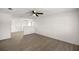 Spacious living room with light wood-look flooring, bright white walls, and an open layout to other rooms at 26 Spring Cir, Ocala, FL 34472