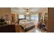 Charming bedroom featuring a ceiling fan, plush carpet, and natural light from the window at 2937 Ne 7Th Pl, Ocala, FL 34470