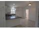 Modern kitchen with white cabinets, dark countertops, and a breakfast bar at 316 Nw Narcissus Rd, Dunnellon, FL 34431