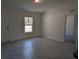 Bright and airy living room with tile floors and a view of the backyard at 316 Nw Narcissus Rd, Dunnellon, FL 34431