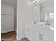 Modern bathroom with double vanities, white cabinets, quartz countertops, and a walk-in shower at 3212 Ne 46Th Ave, Ocala, FL 34470