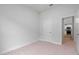 Spacious bedroom with neutral carpet and fresh paint and view to kitchen and stainless appliances at 3212 Ne 46Th Ave, Ocala, FL 34470