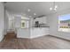 Open-concept kitchen with granite countertops, a breakfast bar, stainless appliances, and hardwood floors at 3212 Ne 46Th Ave, Ocala, FL 34470