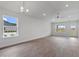 Open-concept living room featuring luxury vinyl plank flooring, a ceiling fan, and large windows at 3212 Ne 46Th Ave, Ocala, FL 34470