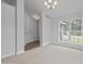 Bright living room featuring neutral walls, carpet, and a large window allowing ample natural light at 3212 Ne 46Th Ave, Ocala, FL 34470