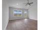 Bright living room with luxury vinyl plank flooring, ceiling fan, and large windows at 3212 Ne 46Th Ave, Ocala, FL 34470