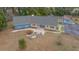 Blue house and detached garage on a large lot with landscaping at 4301 Se 38Th St, Ocala, FL 34480