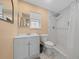 Clean bathroom with white vanity, tiled shower, and penny-round floor at 4301 Se 38Th St, Ocala, FL 34480